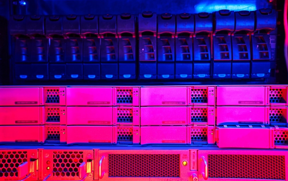 Close up picture of storage server with many HDD disks inside rack in server room